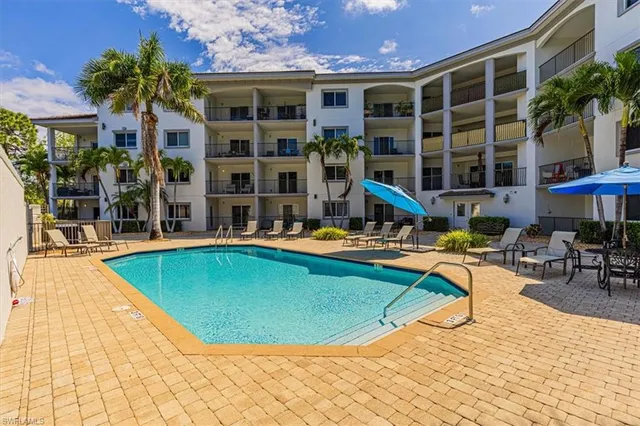 a view of a house with swimming pool and sitting area