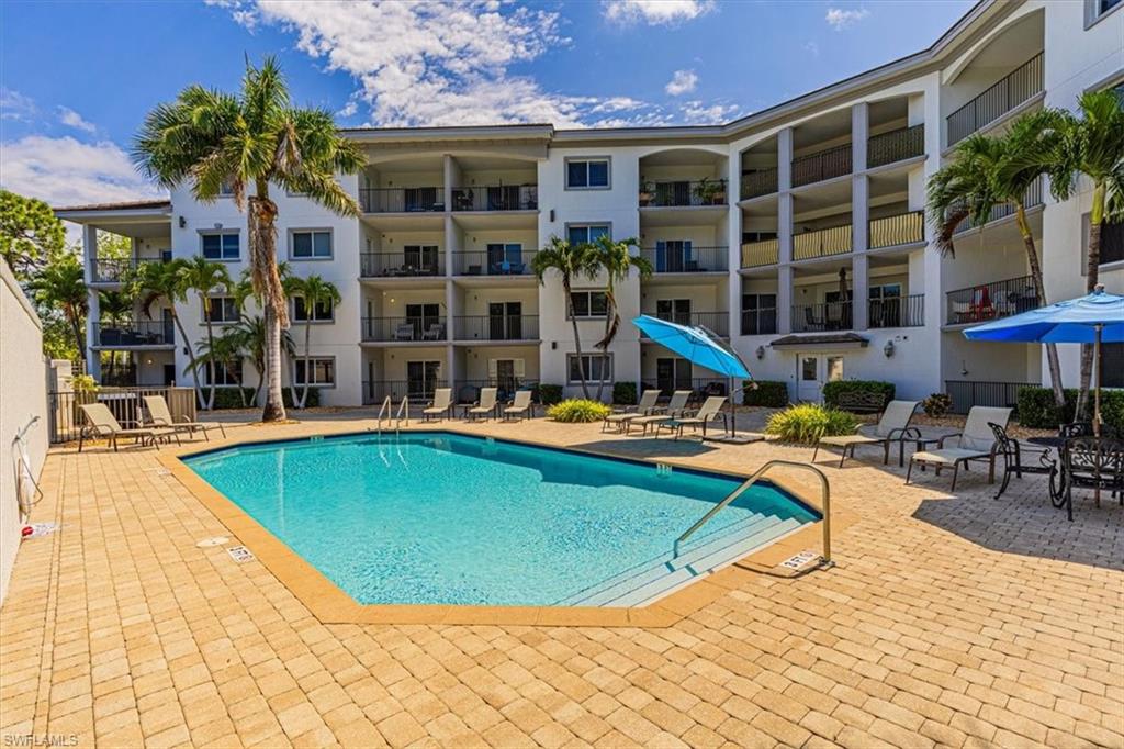 a view of a house with swimming pool and sitting area