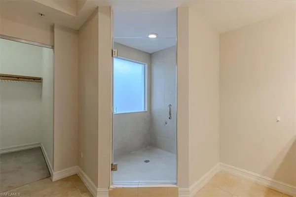 a bathroom with a shower and a sink