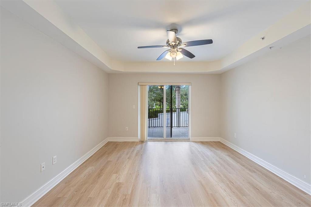 1100 Pine Ridge Road Naples, FL 34108 - Photo 7 of 21 a view of wooden floor and a chandelier fan in a room
