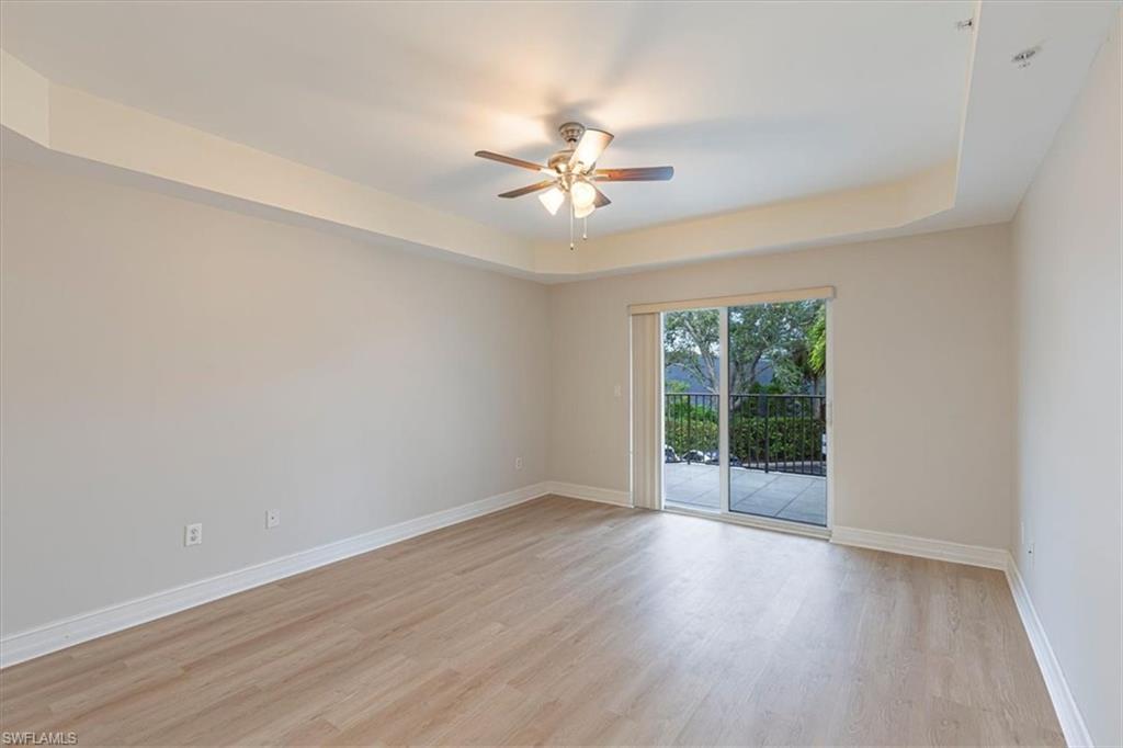 1100 Pine Ridge Road Naples, FL 34108 - Photo 9 of 21 wooden floor in an empty room with a window