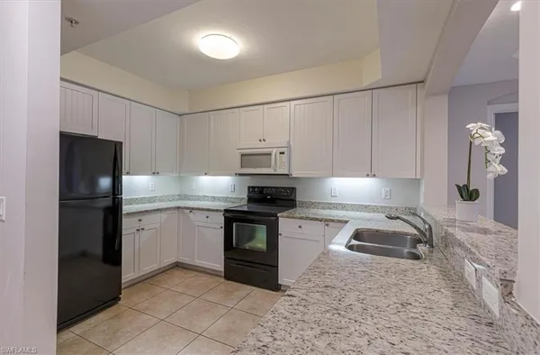 a kitchen with a refrigerator stove and sink