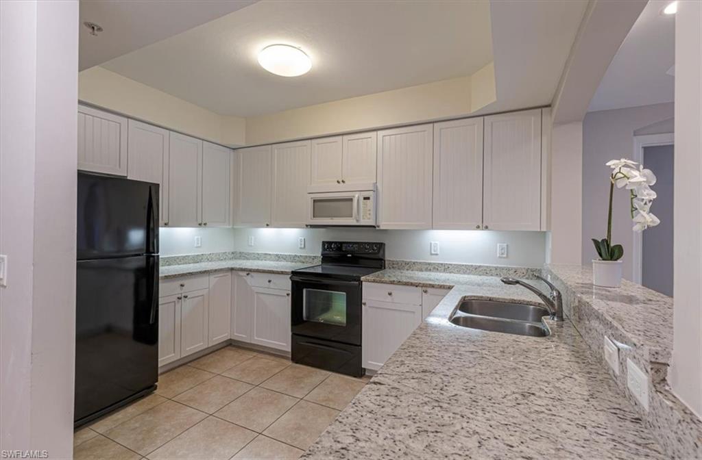 1100 Pine Ridge Road Naples, FL 34108 - Photo 10 of 21 a kitchen with a refrigerator stove and sink