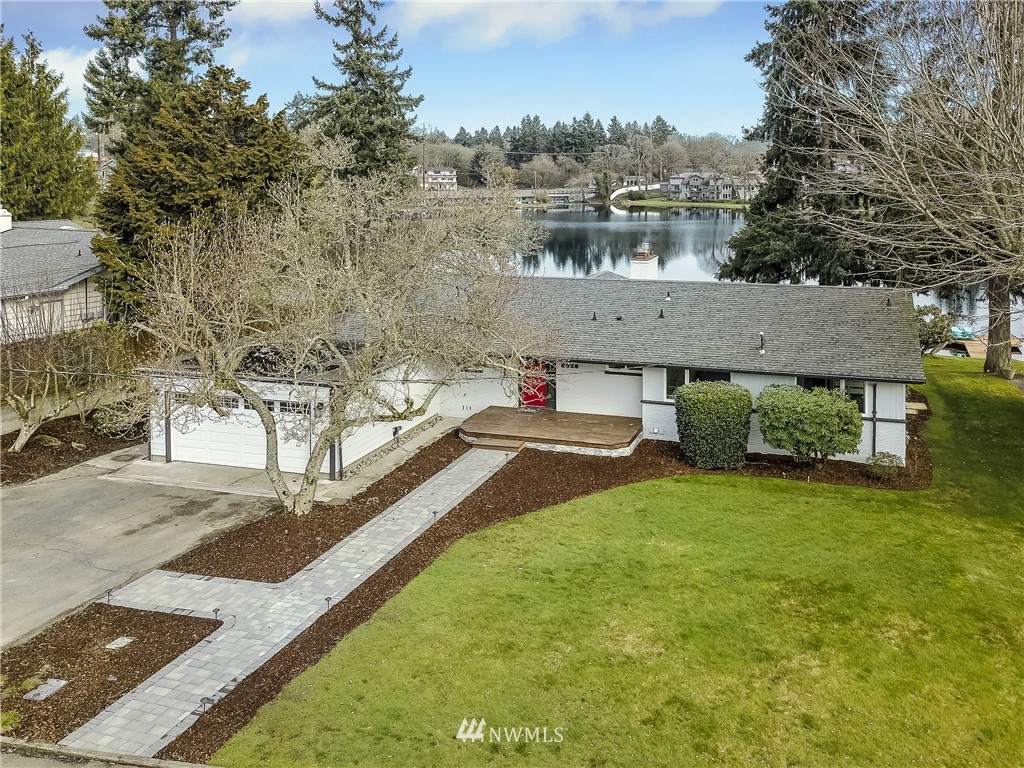 8925 Lake Steilacoom Point Road Southwest Lakewood, WA 98498 - Photo 2 of 31 a view of a house with pool and yard