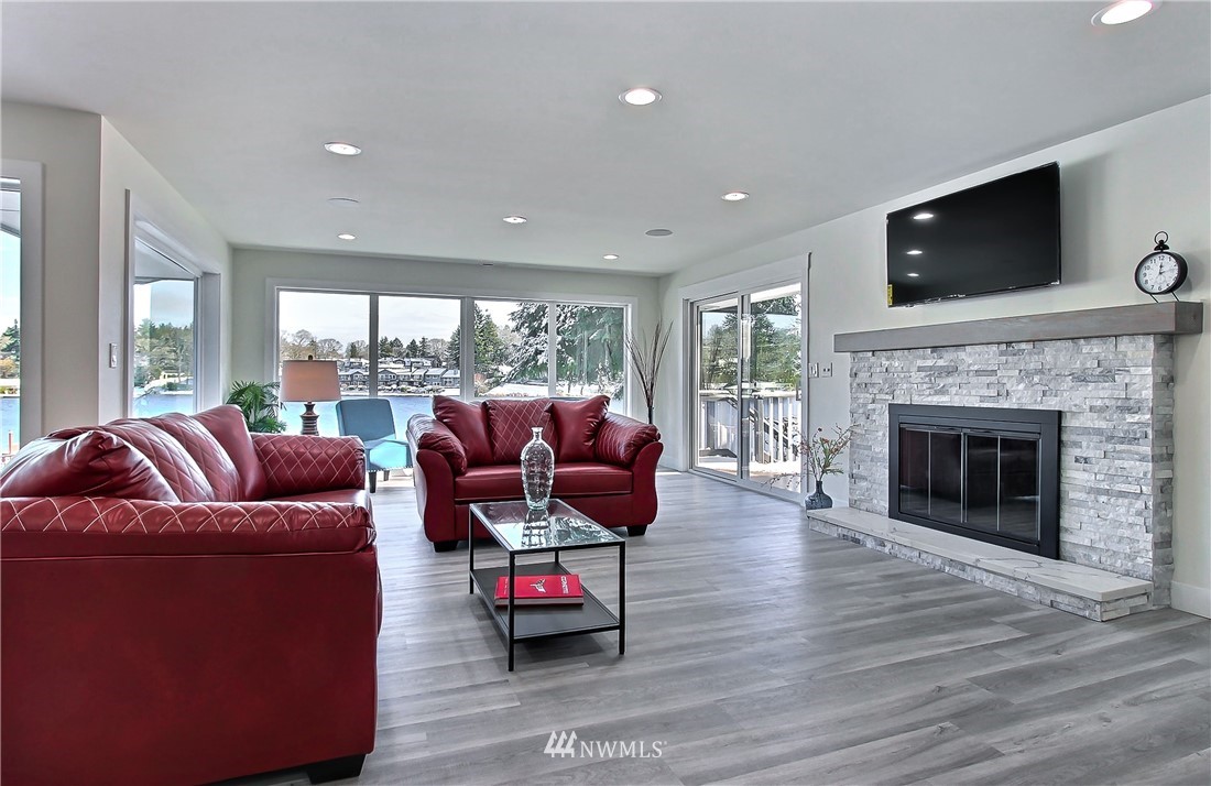 8925 Lake Steilacoom Point Road Southwest Lakewood, WA 98498 - Photo 12 of 31 a living room with furniture a flat screen tv and a fireplace