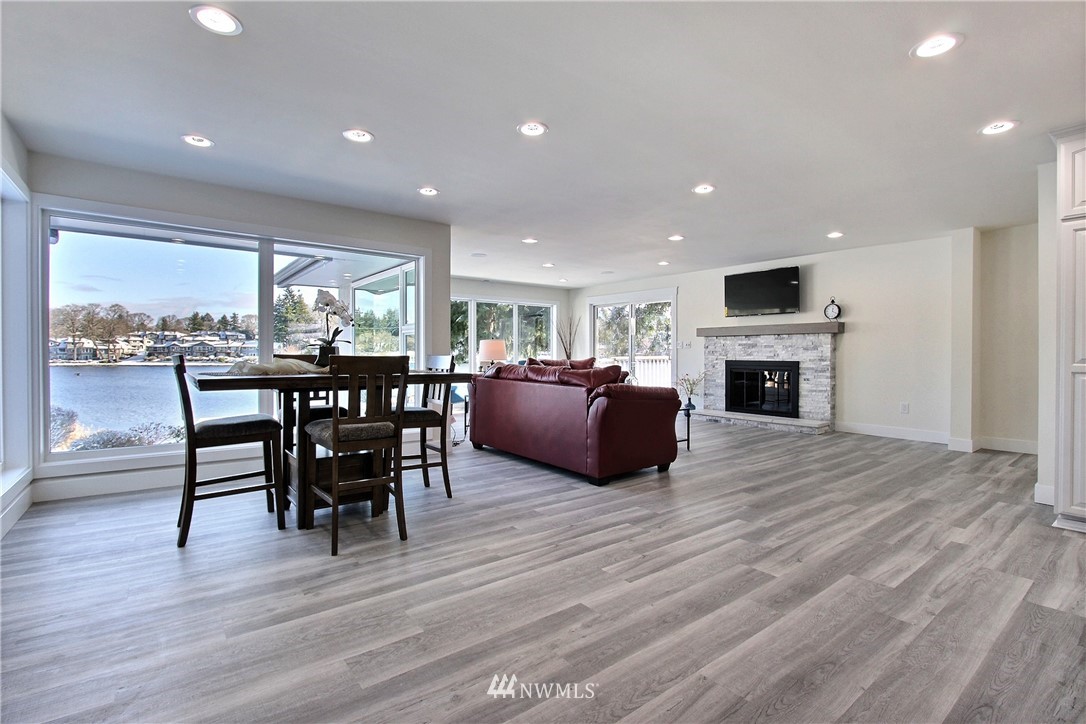 8925 Lake Steilacoom Point Road Southwest Lakewood, WA 98498 - Photo 13 of 31 a living room with furniture a fireplace and a flat screen tv