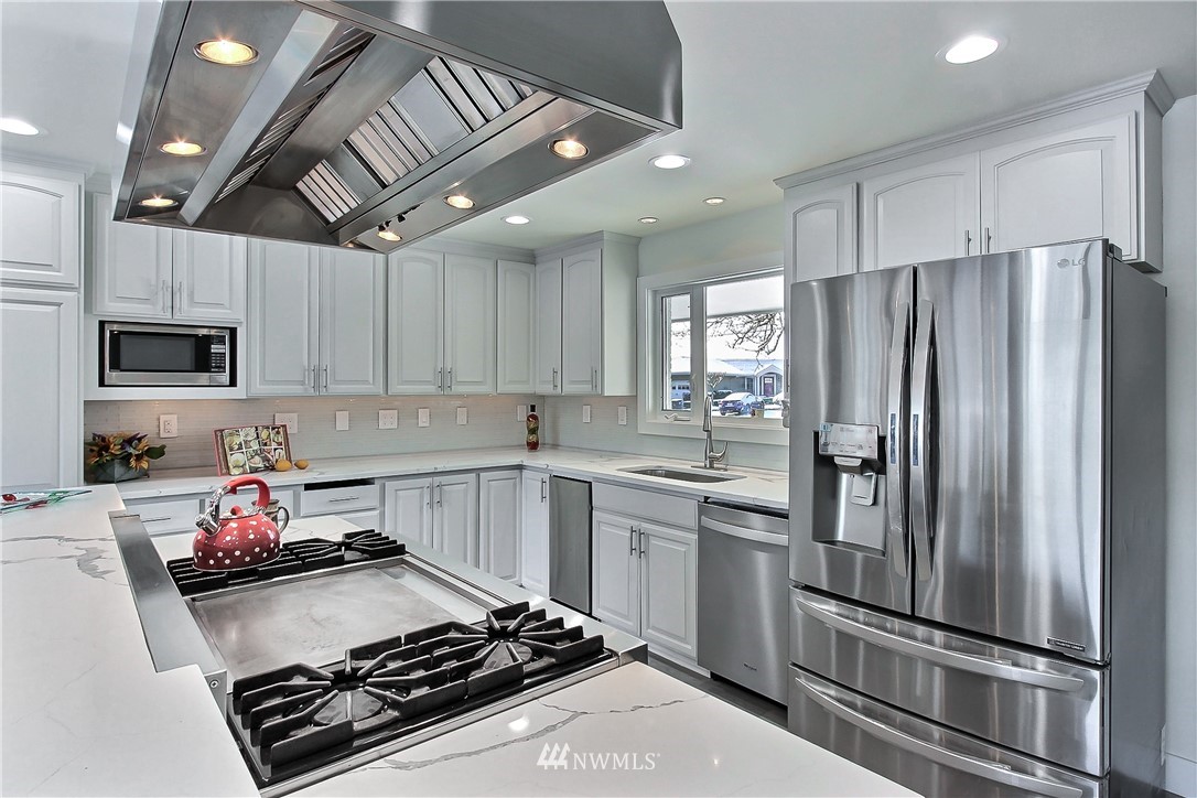 8925 Lake Steilacoom Point Road Southwest Lakewood, WA 98498 - Photo 15 of 31 a kitchen with refrigerator a stove and a sink