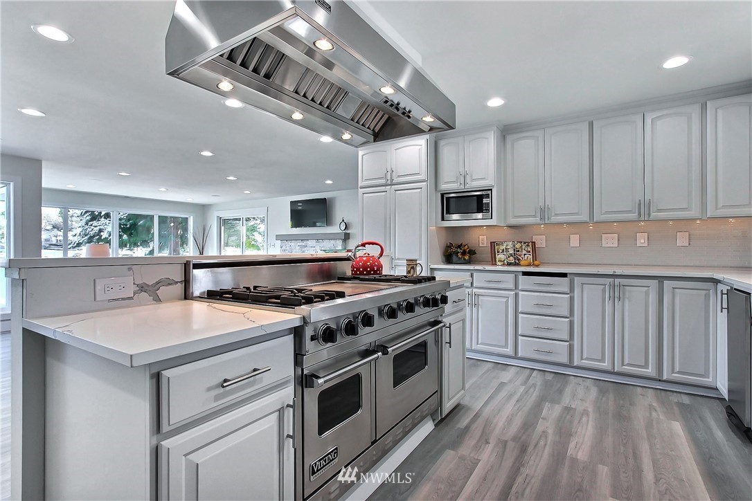 8925 Lake Steilacoom Point Road Southwest Lakewood, WA 98498 - Photo 16 of 31 a kitchen with stainless steel appliances granite countertop a stove and a sink