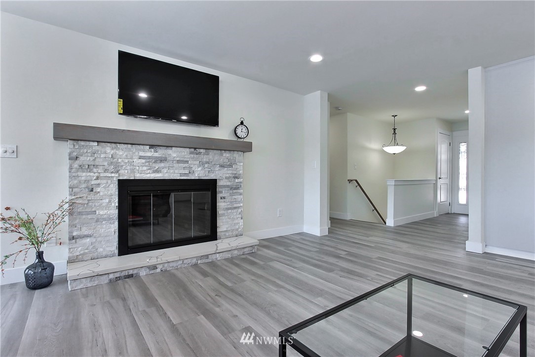 8925 Lake Steilacoom Point Road Southwest Lakewood, WA 98498 - Photo 17 of 31 a view of a livingroom with a fireplace and wooden floor
