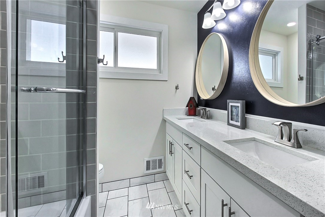 8925 Lake Steilacoom Point Road Southwest Lakewood, WA 98498 - Photo 18 of 31 a bathroom with a double vanity sink and a mirror