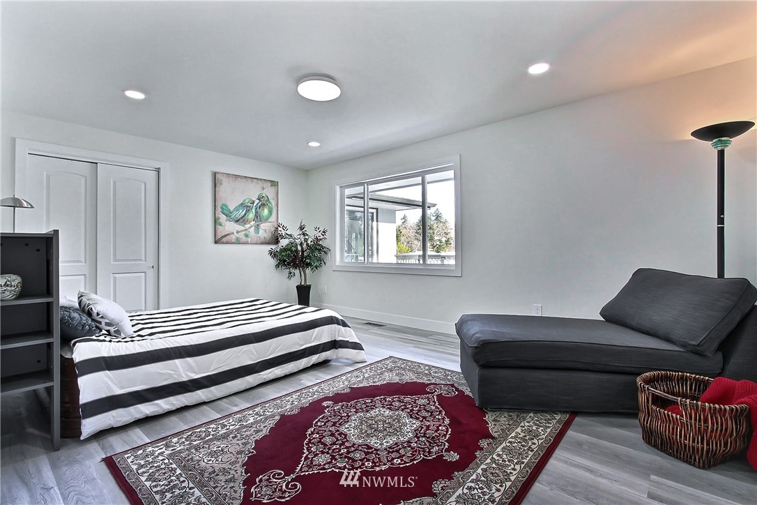 8925 Lake Steilacoom Point Road Southwest Lakewood, WA 98498 - Photo 19 of 31 a bedroom with furniture and a rug