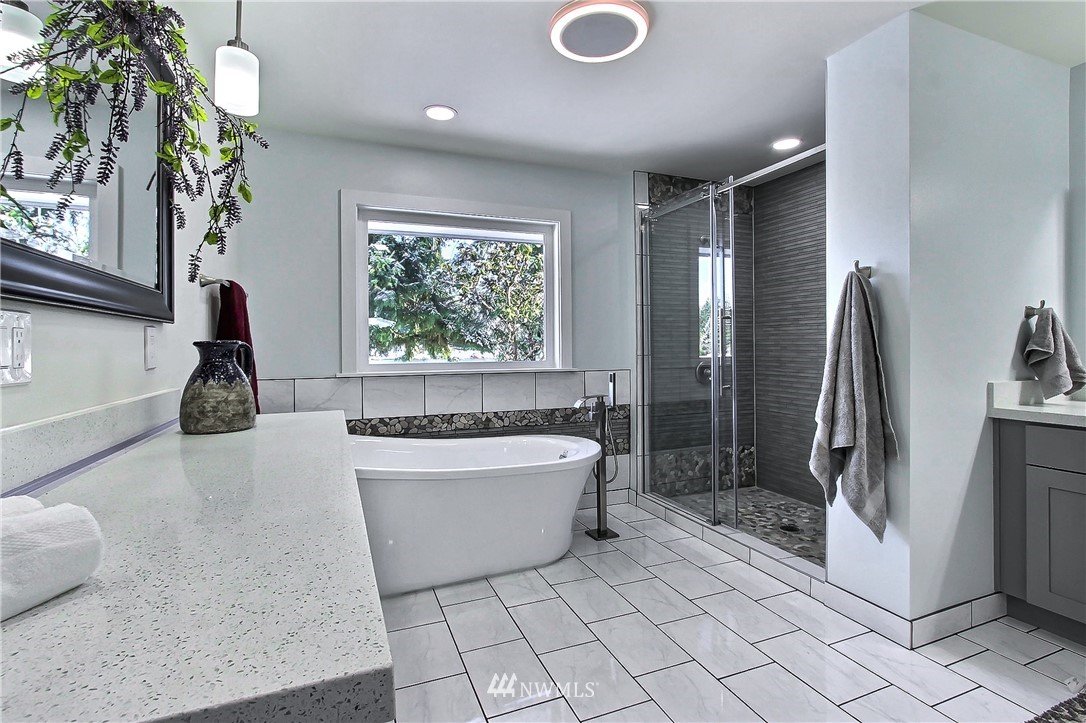 8925 Lake Steilacoom Point Road Southwest Lakewood, WA 98498 - Photo 20 of 31 a bathroom with a tub a mirror and shower
