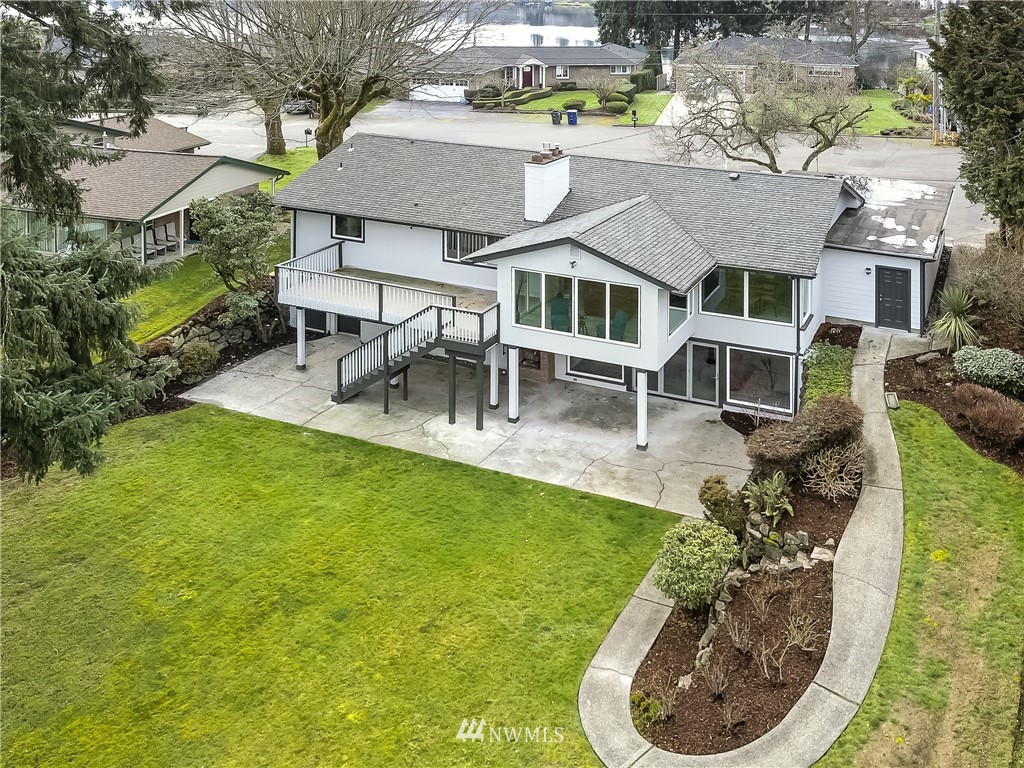 8925 Lake Steilacoom Point Road Southwest Lakewood, WA 98498 - Photo 3 of 31 a view of a house with a backyard porch and sitting area