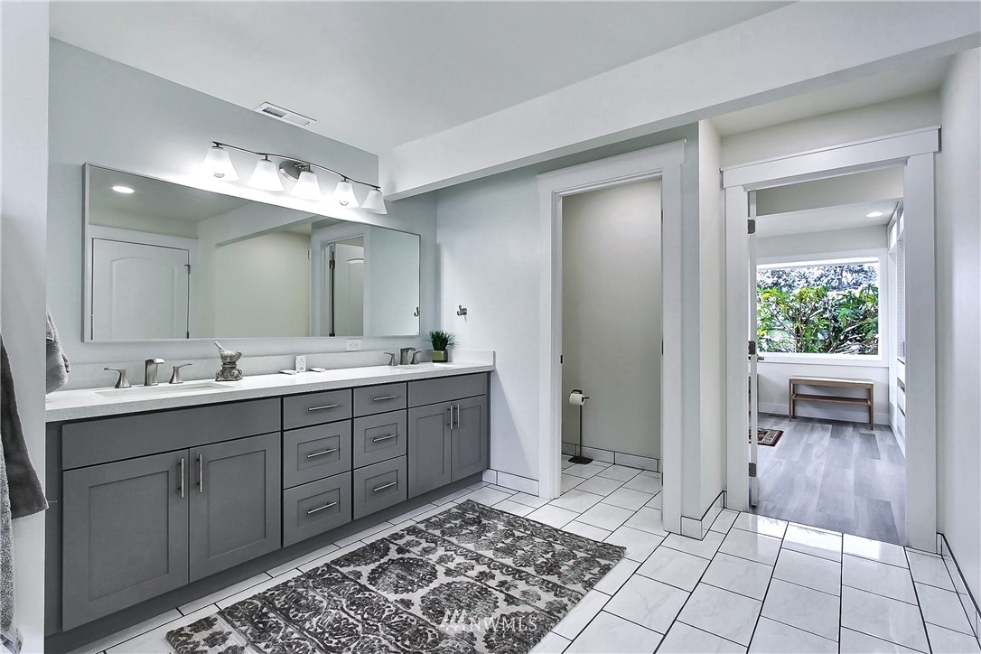 8925 Lake Steilacoom Point Road Southwest Lakewood, WA 98498 - Photo 21 of 31 a spacious bathroom with a double vanity sink and a mirror