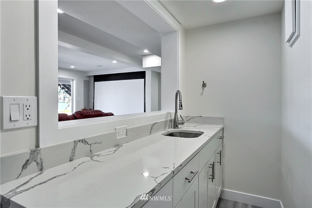 8925 Lake Steilacoom Point Road Southwest Lakewood, WA 98498 - Photo 26 of 31 a bathroom with a double vanity sink and a mirror