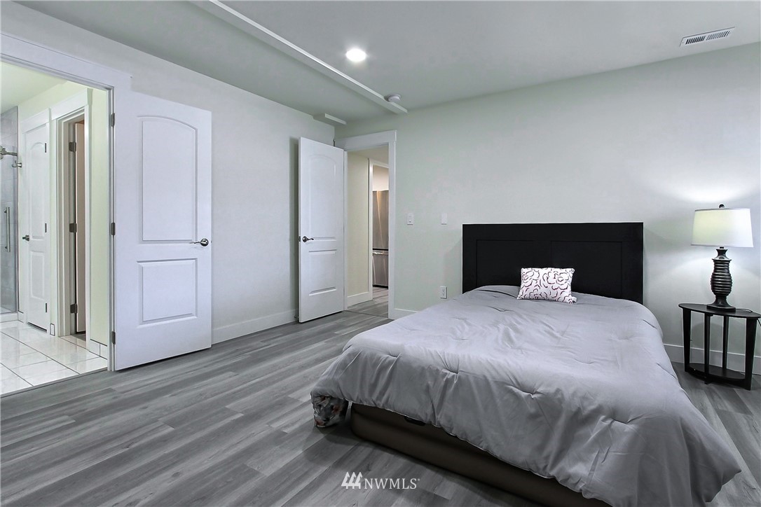 8925 Lake Steilacoom Point Road Southwest Lakewood, WA 98498 - Photo 30 of 31 a bedroom with a bed and lamps