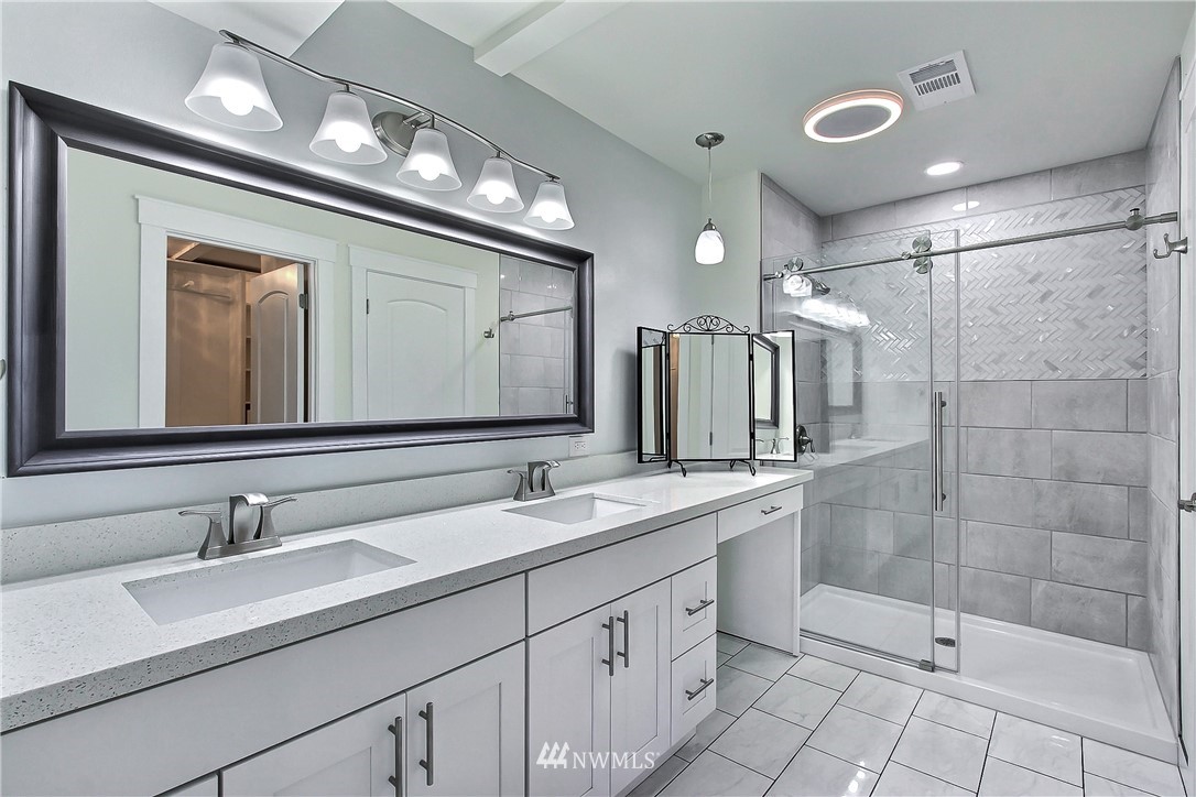 8925 Lake Steilacoom Point Road Southwest Lakewood, WA 98498 - Photo 31 of 31 a bathroom with a double vanity sink mirror and shower
