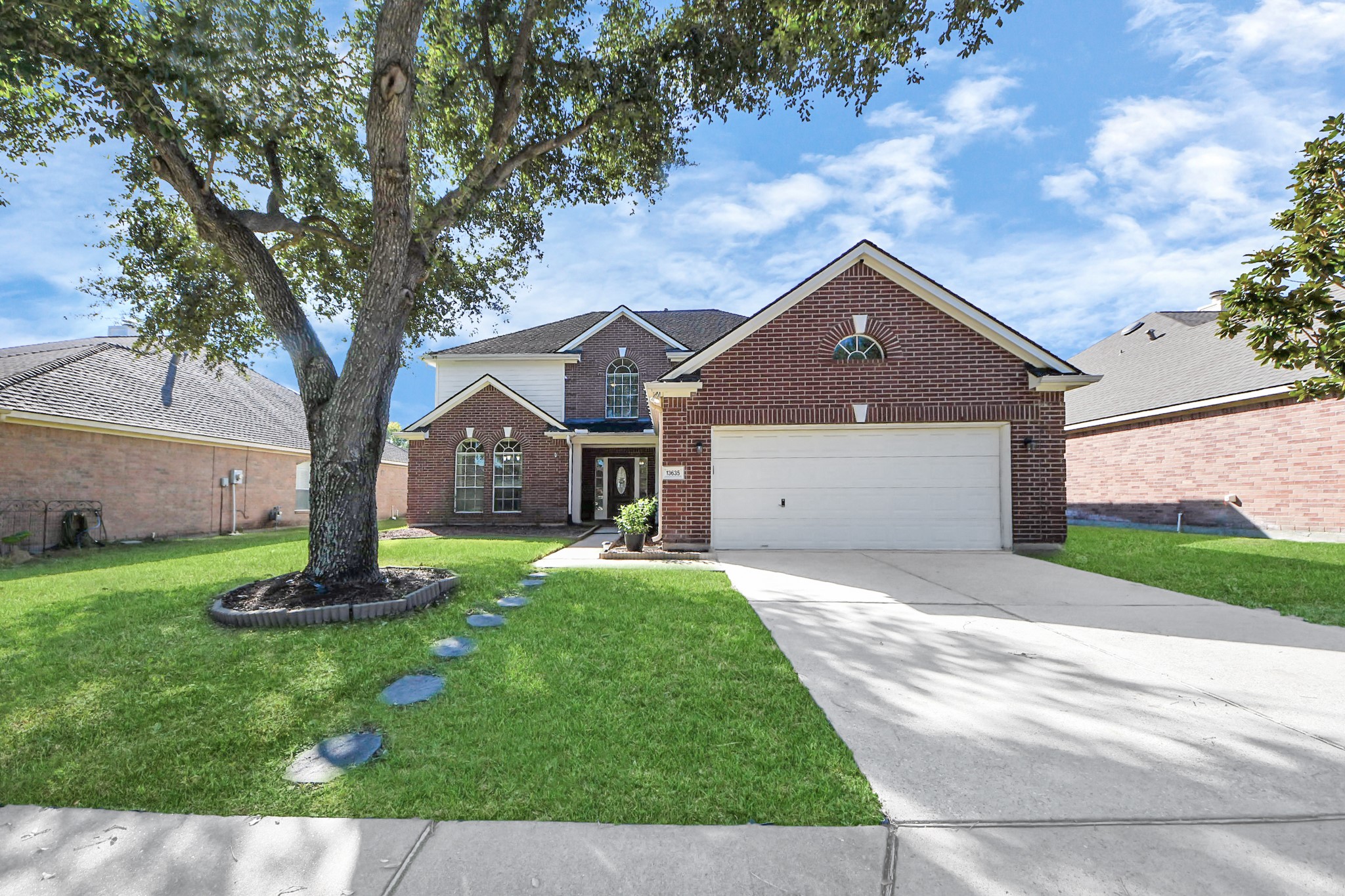 13635 Treebank Lane Houston, TX 77070 - Photo 1 of 37 a front view of a house with a garden