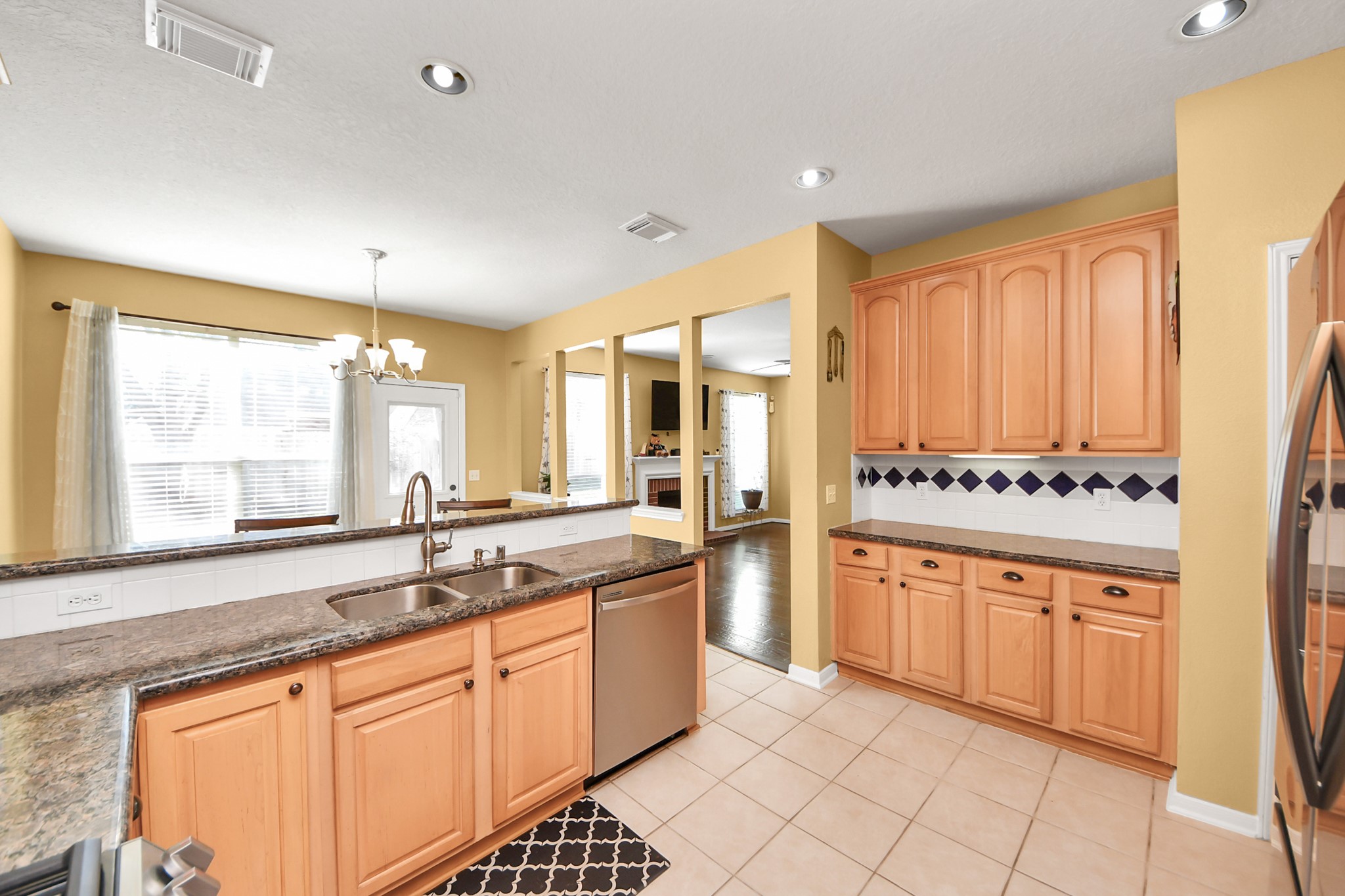 13635 Treebank Lane Houston, TX 77070 - Photo 11 of 37 a large kitchen with granite countertop a sink and white cabinets