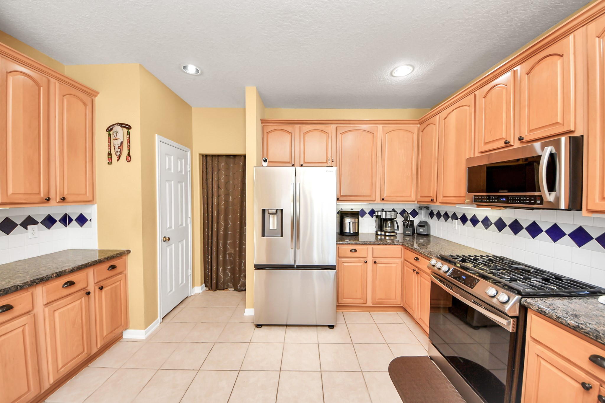 13635 Treebank Lane Houston, TX 77070 - Photo 12 of 37 a kitchen with stainless steel appliances a refrigerator sink and cabinets