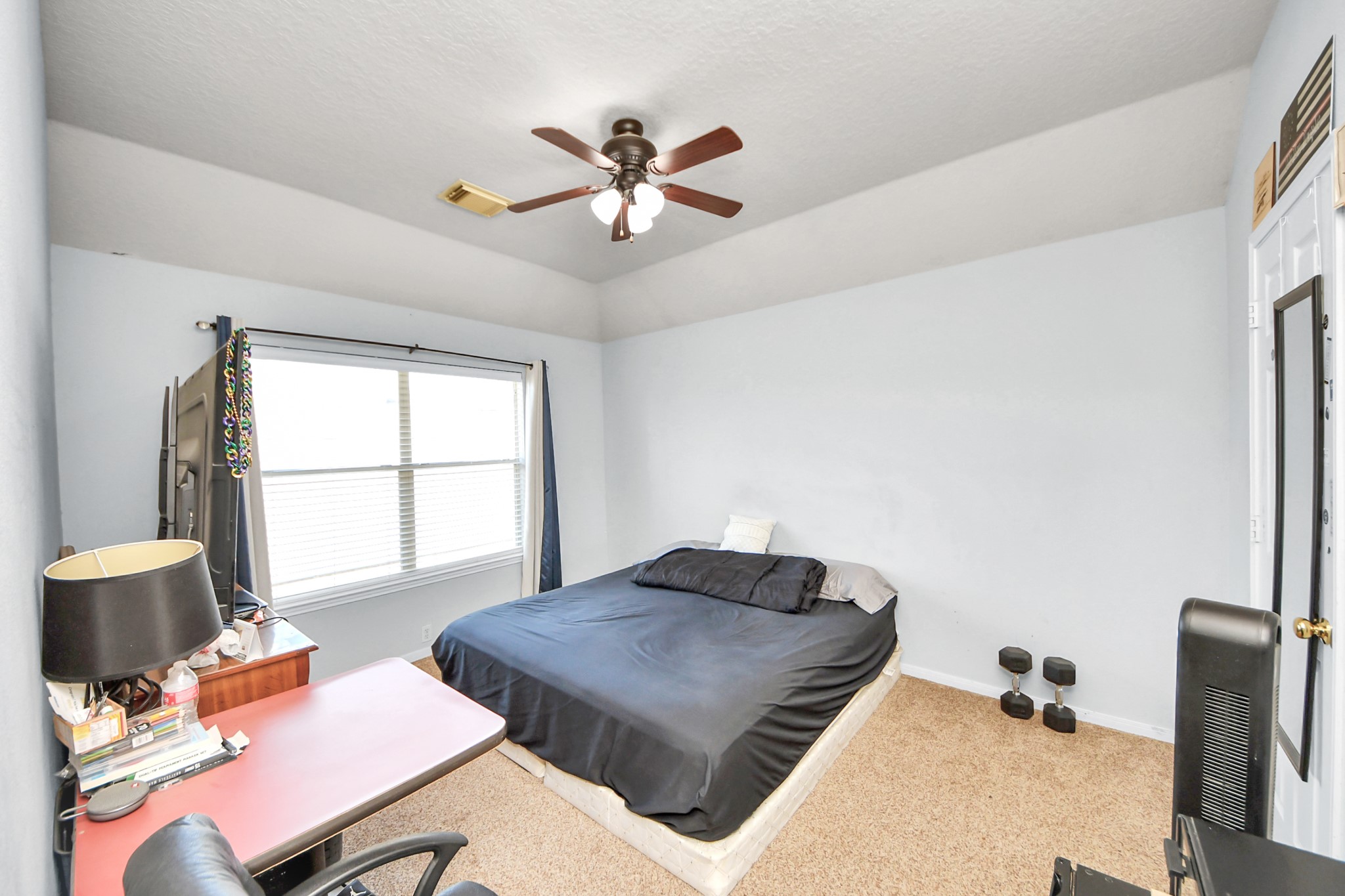 13635 Treebank Lane Houston, TX 77070 - Photo 20 of 37 a bedroom with a bed and wooden floor