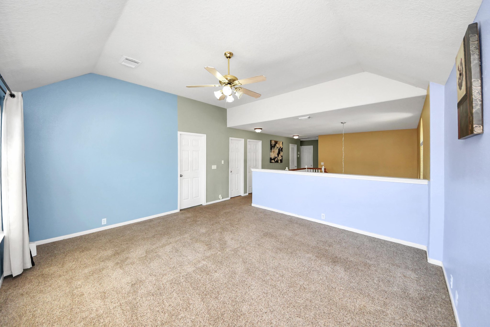 13635 Treebank Lane Houston, TX 77070 - Photo 27 of 37 an empty room with a chandelier fan and a kitchen