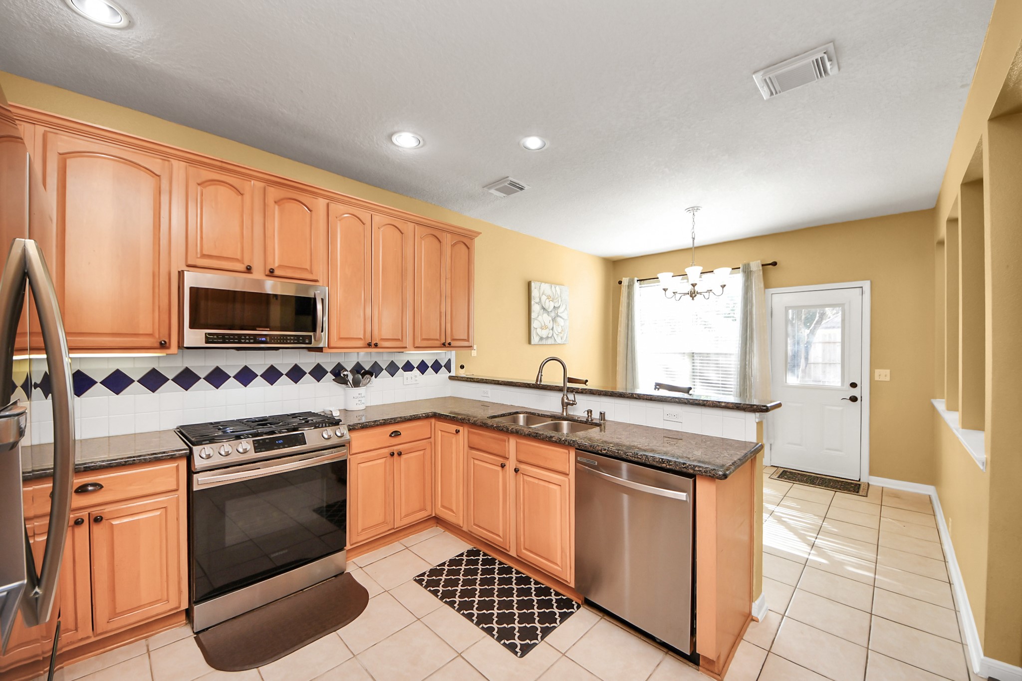 13635 Treebank Lane Houston, TX 77070 - Photo 10 of 37 a kitchen with stainless steel appliances granite countertop a stove sink and cabinets