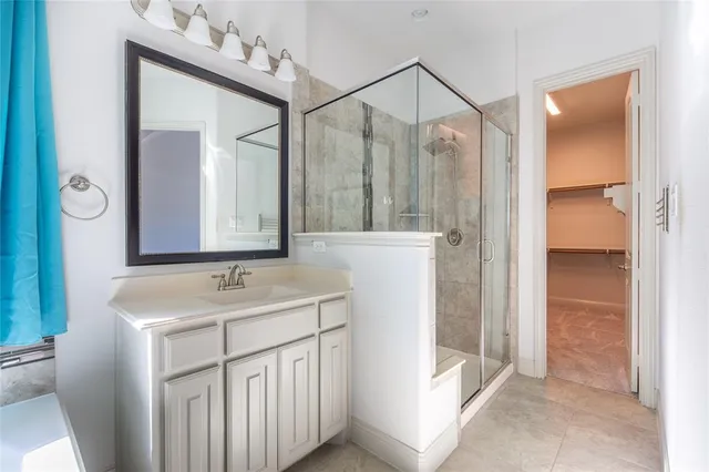 a bathroom with a sink vanity and a mirror