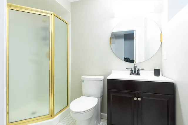 a bathroom with a sink toilet and mirror