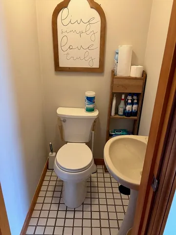 a bathroom with a toilet and a mirror