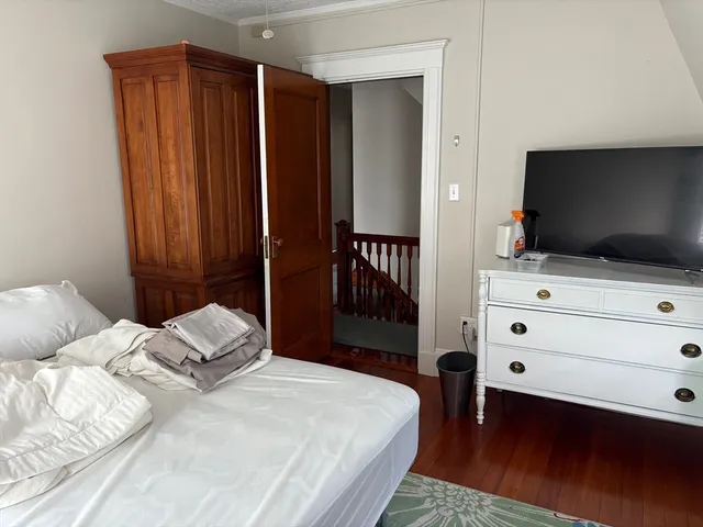 a bedroom with a bed and flat screen tv