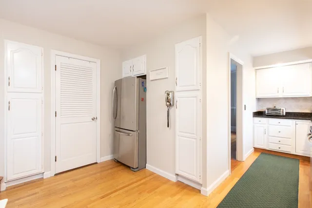 a kitchen with a refrigerator and a stove