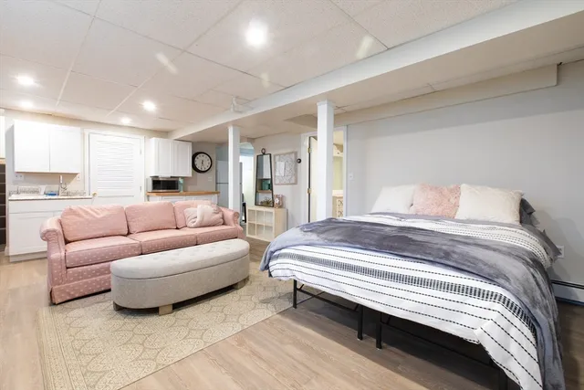 a spacious bedroom with a bed couch and a window