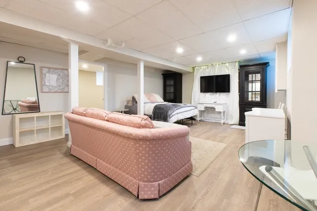 a living room with furniture a flat screen tv and kitchen view