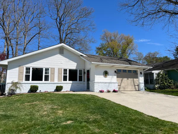 a front view of house with yard and green space