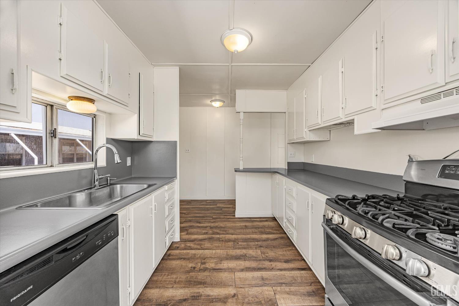 Undisclosed Address Bakersfield, CA 93306 - Photo 13 of 30 a kitchen with stainless steel appliances granite countertop a sink stove and cabinets