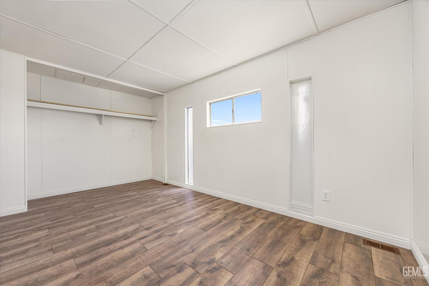 Undisclosed Address Bakersfield, CA 93306 - Photo 18 of 30 a view of an empty room with wooden floor
