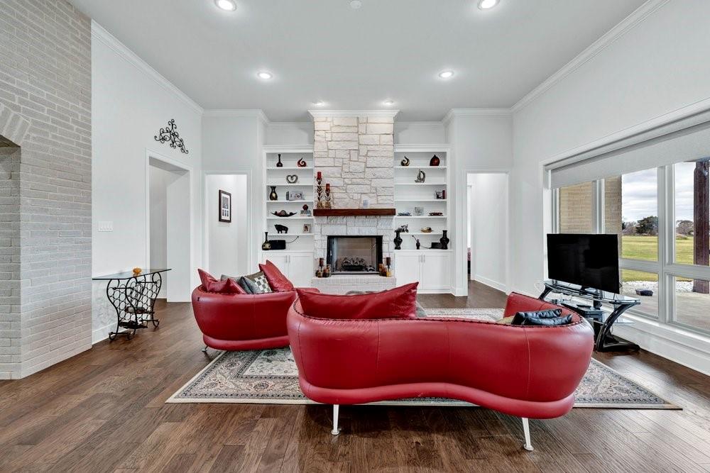 580 County Road 3422 Wills Point, TX 75169 - Photo 12 of 38 a living room with furniture a flat screen tv and a fireplace