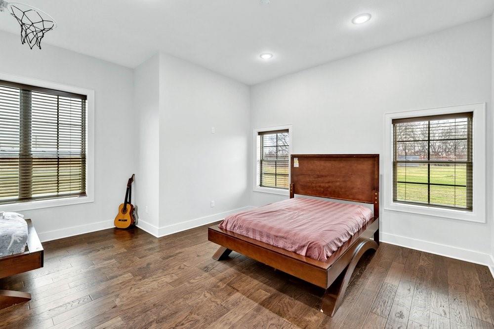 580 County Road 3422 Wills Point, TX 75169 - Photo 27 of 38 a bedroom with a bed and wooden floor