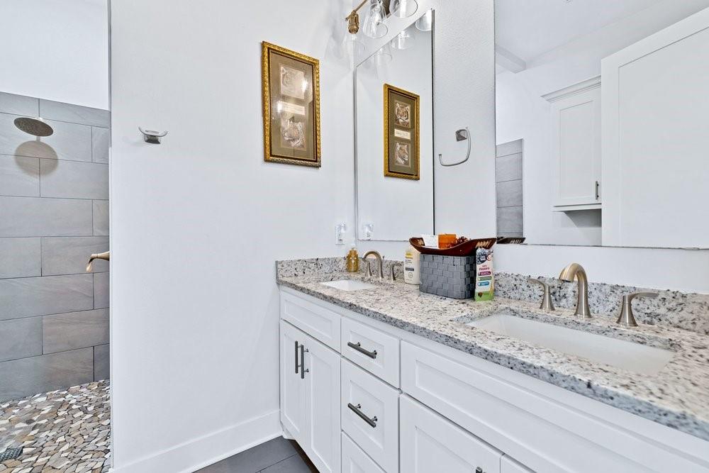 580 County Road 3422 Wills Point, TX 75169 - Photo 30 of 38 a bathroom with a granite countertop sink and a mirror