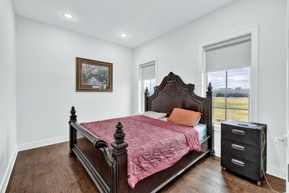 580 County Road 3422 Wills Point, TX 75169 - Photo 31 of 38 a bedroom with a bed and wooden floor