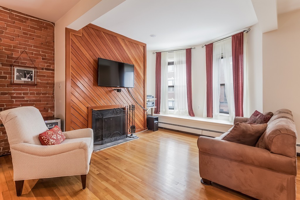 36 Symphony Road, Unit 3B Boston, MA 02115 - Photo 1 of 21 a living room with furniture a fireplace and a flat screen tv
