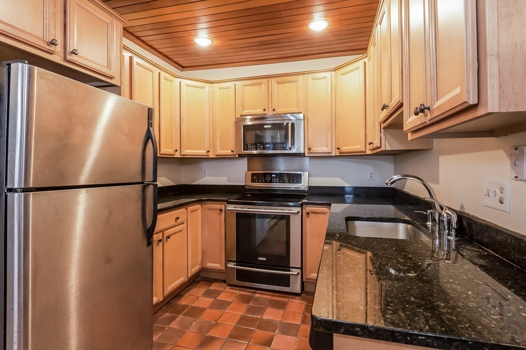 36 Symphony Road, Unit 3B Boston, MA 02115 - Photo 11 of 21 a kitchen with stainless steel appliances granite countertop a refrigerator a sink and a stove