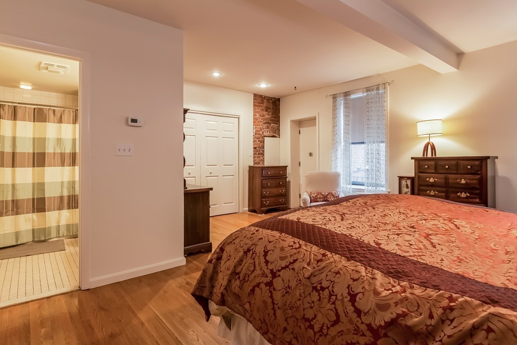 36 Symphony Road, Unit 3B Boston, MA 02115 - Photo 17 of 21 a spacious bedroom with a bed and a dresser