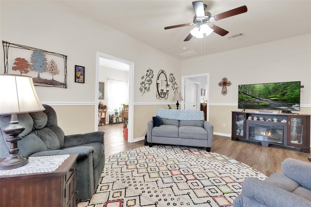 201 East Walker Street Denison, TX 75021 - Photo 4 of 19 a living room with furniture and a flat screen tv