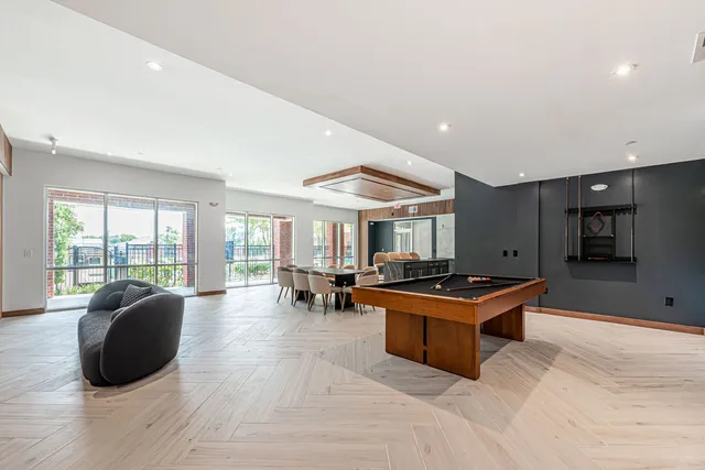 a living room with furniture a flat screen tv and a large window
