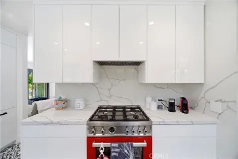 a white stove top oven sitting inside of a kitchen