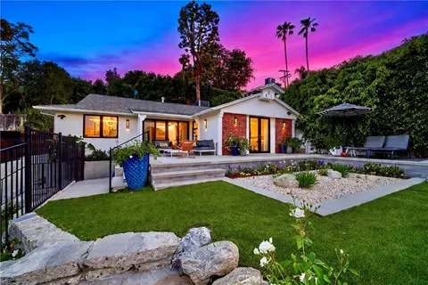 a view of a house with swimming pool and a yard