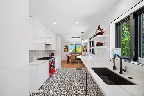 a kitchen with granite countertop lots of counter top space and wooden floor