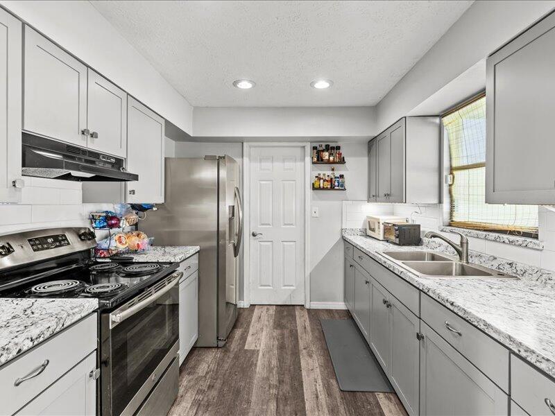 1297 Southeast Floresta Drive Port St. Lucie, FL 34983 - Photo 11 of 42 a kitchen with a sink stove and refrigerator
